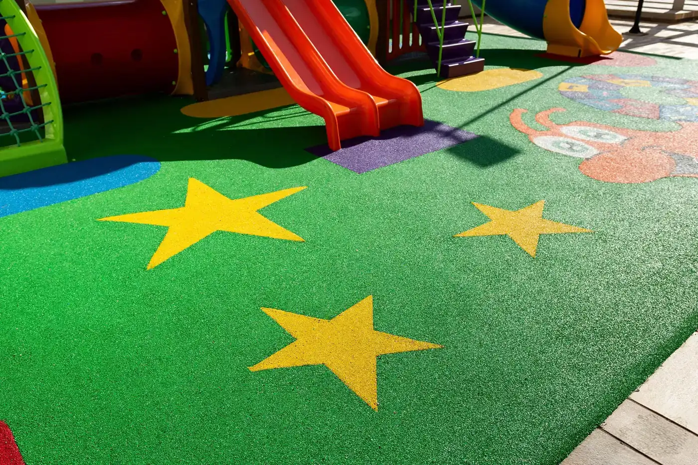 Estrelas amarelas em EPDM integradas ao piso de borracha verde